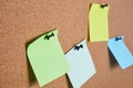 several colored note sheets pinned to cork board, selective focus, copy space Royalty Free Stock Photo