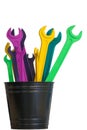 Several colored open end wrenches stand in a black bucket isolated on a white background Royalty Free Stock Photo