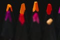 several colored pencils, brightly colored tips with selective focus, black background.