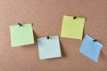 several colored stickers for notes pinned to cork board Royalty Free Stock Photo