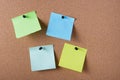 several colored stickers for notes pinned to cork board Royalty Free Stock Photo