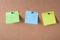 several colored stickers for notes pinned to cork board Royalty Free Stock Photo