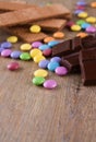 Several colorful chocolate smarties on wooden board Royalty Free Stock Photo