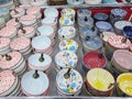 Several colorful clay porcelain bowls utensils for sale on display