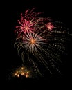 Several colorful fireworks exploding in the dark sky in the middle of the night. The explosions light the sky creating colorful Royalty Free Stock Photo