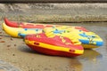 Several colorful inflatable boats are parked on the beach