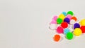 several colorful little poms on a white background