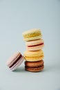 Several colorful macaroon cakes on a colored background