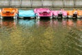 Several colorful paddle boats floating Royalty Free Stock Photo