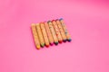 Several colorful wooden crayons isolated on pink background with copy space Colored drawing pencils for kids Royalty Free Stock Photo