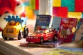 Several colorful books for children, toy car and toy truck