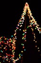 Several colors of blurry lights decorated all over a Christmas tree.