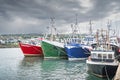 Several colourful fishing boats moored in Howth harbour, Dublin, Ireland