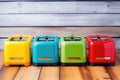 several colourful toasters aligned on wooden surface