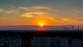 Several construction cranes on the background of colorful sunset sky