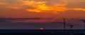 Several construction cranes on the background of colorful sunset sky