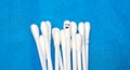 Several cotton swabs in a pile, one of which has a face on it. The concept of standing out from the crowd Royalty Free Stock Photo