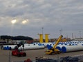 Cranes load parts of onshore-offshore wind towers in the harbour of Aviles