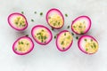 Several creamy and delicious bright pink devilled eggs for Easter.