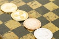 Several cryptocurrencies, bitcoin, ethereum, litecoin, ripple on chessboard