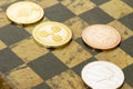 Several cryptocurrencies, bitcoin, ethereum, litecoin, ripple on chessboard