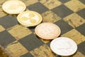 Several cryptocurrencies, bitcoin, ethereum, litecoin, ripple on chessboard