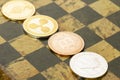 Several cryptocurrencies, bitcoin, ethereum, litecoin, ripple on chessboard