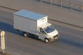 Several delivery van and white logistic truck driving on the highway Royalty Free Stock Photo