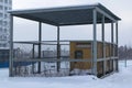 Several diesel generators stand under a canopy is fenced with a metal grid