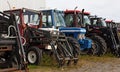 Several different agricultural tractors standing in a row Royalty Free Stock Photo