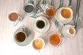 Several different cups and mugs with coffee and tea drinks on a light table with a blue gray towel, high angle view from above, Royalty Free Stock Photo