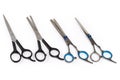 Several different professional stainless steel hair scissors on white background