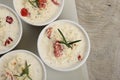 Several dishes with casserole - sour cream, tomatoes and fish or other ingredients before baking