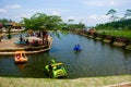 several duck boats, crossing an artificial lake