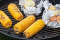 Several ears of corn are roasted on a round grill Royalty Free Stock Photo