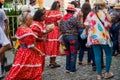 Several elderly people are seen walking in the streets of Pelourinho dressed in clothes from the feast of Sao Joao