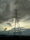 Several electric towers stand with the atmosphere of the sky full of dark clouds Royalty Free Stock Photo