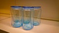Several empty blue glass jars stand on a shelf