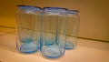 Several empty blue glass jars stand on a shelf