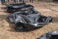 Several empty corpse body bag lie on the ground (crime concept)