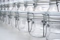 Several empty glass jars with lip-top closures in a zero waste shop, selective focus