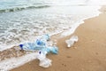 Several empty plastic bottles lying on the seashore near the water, the concept of environmental safety Royalty Free Stock Photo