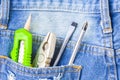 Several equipment tools in back pocket jean workers with copyspace. Royalty Free Stock Photo