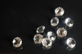 Several excellent pure diamonds with reflection on black mirror background close up view. Jewelry diamonds sale, invitation,