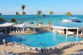 Several families enjoying their holidays time in the swimming pool of a luxury hotel resort placed close to a caribbean beach