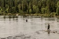 several fishermen catch fish in Imandra lake in Karelia