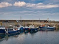 Several fishing boats moored in the harbour at Seahouses on the Northumberland coast in the north east of England Royalty Free Stock Photo