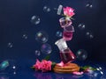 Several flasks are in the air. Levitation. Pink roses and soap bubbles. Magic, mystical picture. Blue background