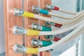 Several flexible electrical cables or wires are attached to copper buses