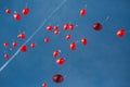 Several flying red heart-shaped balloons in blue sky at wedding Royalty Free Stock Photo